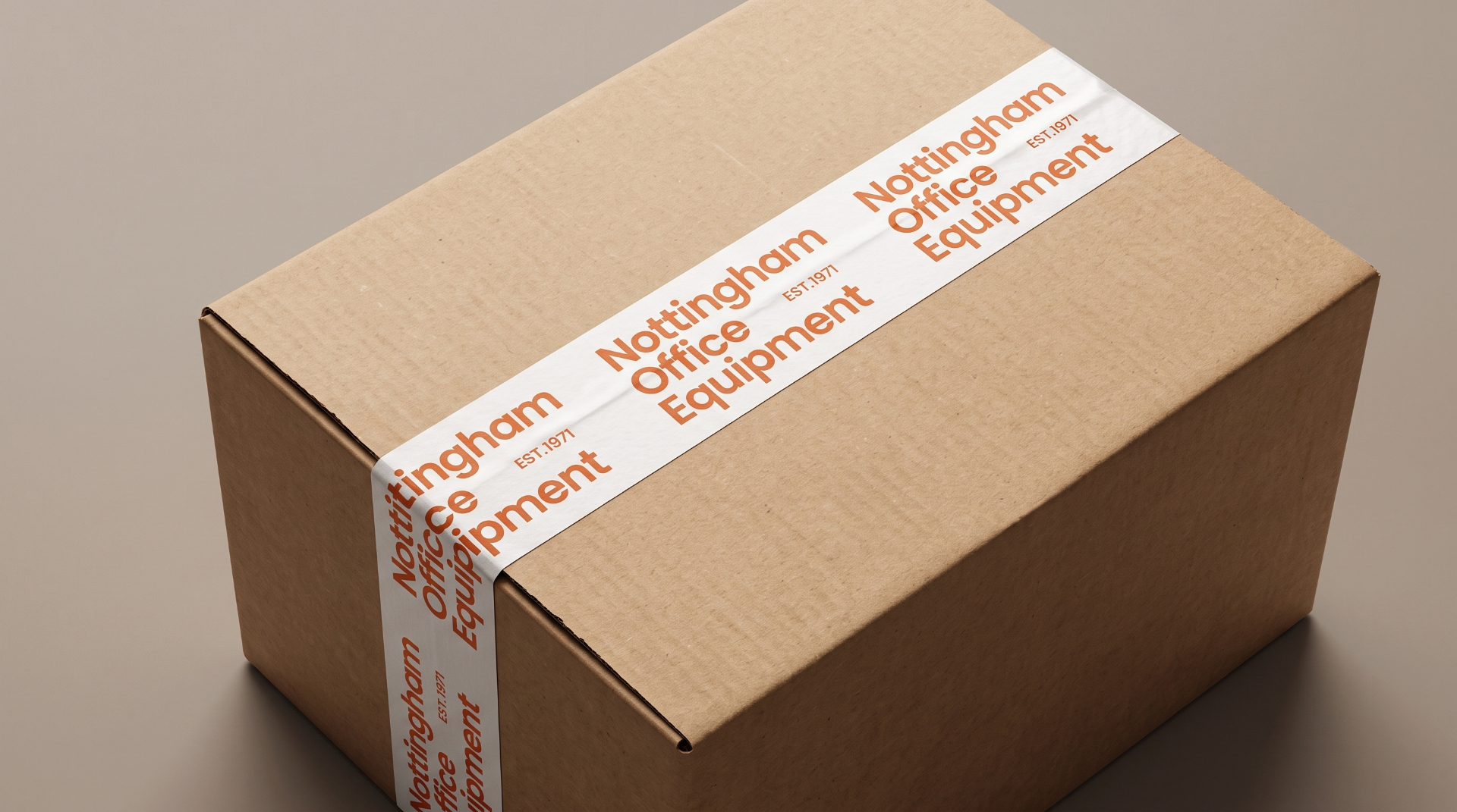 Kraft cardboard box sealed with white branded tape repeating the wordmark in orange